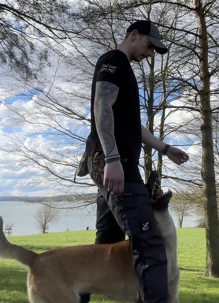 Loose-lead heelwork beside a lake